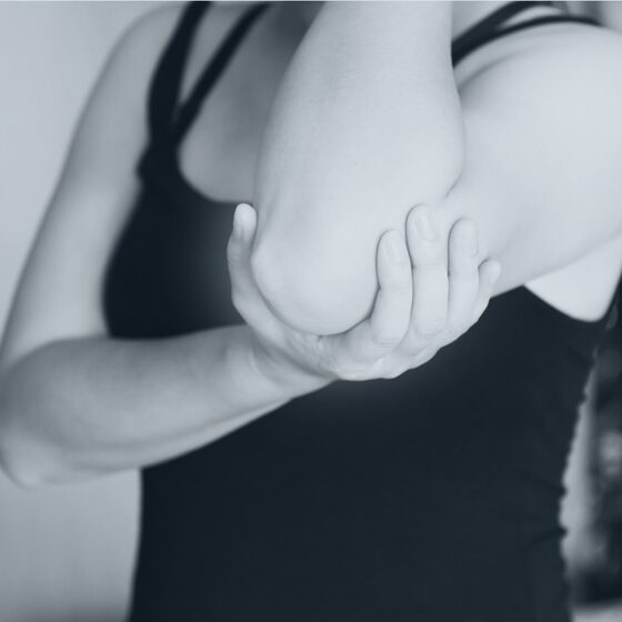 A person supporting a sore elbow and forearm.